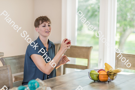 A young lady grabbing fruit stock photo with image ID: b43c479a-ee5e-4173-a120-f78e7c87a0c4