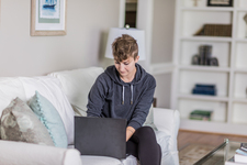 A young lady sitting on the couch