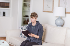 A young lady sitting on the couch