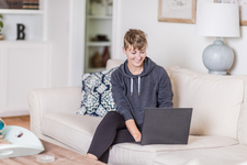 A young lady sitting on the couch