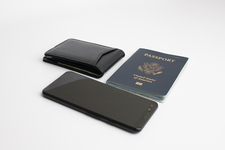 A mobile phone, with a black leather wallet, and US passport